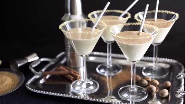 Egg nog cocktail in glasses rimmed with brown sugar at the minibar