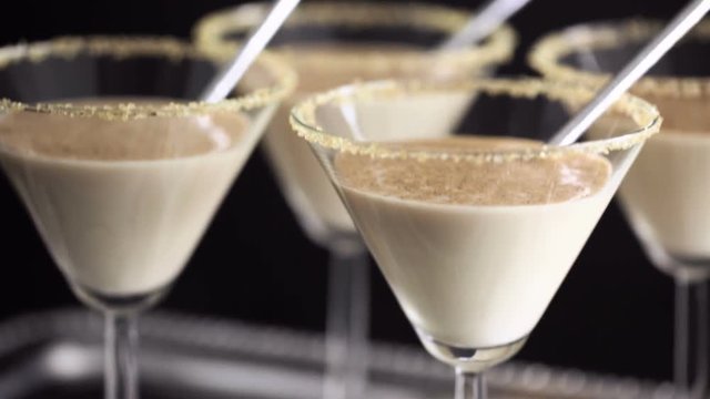Egg nog cocktail in glasses rimmed with brown sugar at the minibar
