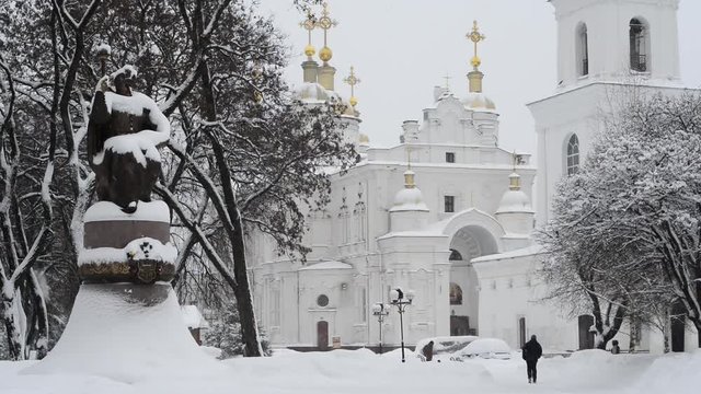Winter. It is snowing. View of the Cathedral Square in Poltava in Ukraine. On the square are a monument to the outstanding Ukrainian Hetman Ivan Mazepa.