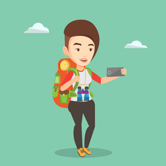Woman with backpack making selfie.