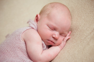 Newborn baby sleeping on a blanket. Close-up