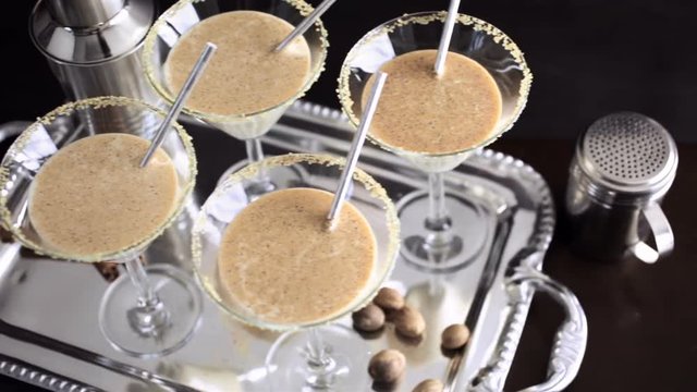 Egg nog cocktail in glasses rimmed with brown sugar at the minibar