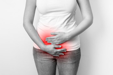 Woman with menstrual pain is holding her aching belly