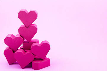 Stack of paper box red heart shape on pink background with copy