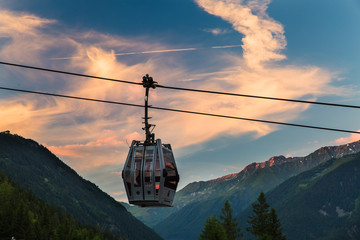 A solitary gondola hangs from a cable in Chamonix, France during sunset © Jeremy Francis