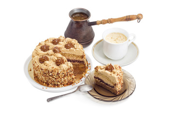 Partly sliced sponge cake, coffee in cup and coffee pot