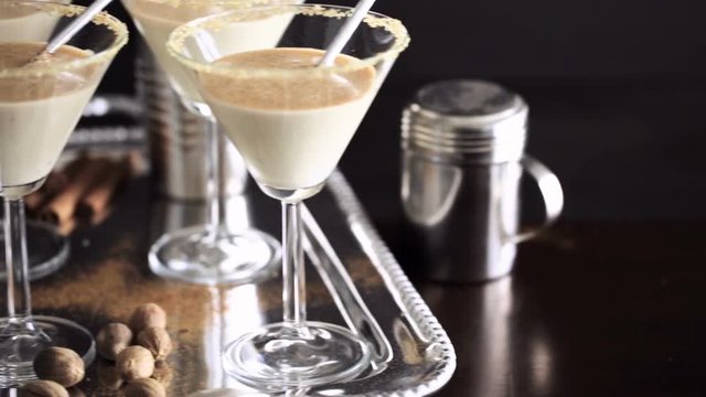 Egg nog cocktail in glasses rimmed with brown sugar at the minibar
