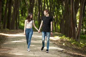 Fototapeta na wymiar Couple walking in park and laughing