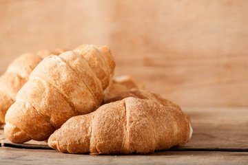 Fresh croissant on wood desk
