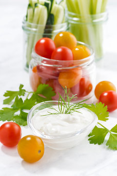 healthy snacks, mixed vegetables and yogurt on white background