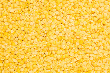 Yellow purified lentil closeup top view background. Healthy protein food.