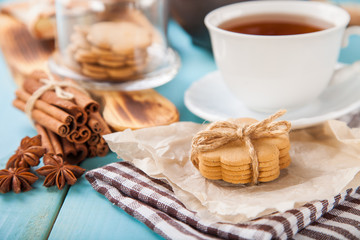 Obraz na płótnie Canvas cookies with cinnamon and tea on a table, selective focus, copy space