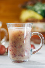 Grape smoothie over the white table.