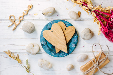 Two wooden hearts on blue plate - Valentine's day concept