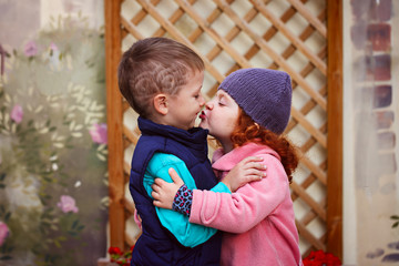 Little girl kissed for the first time adorable little boy. Love and romantic concept