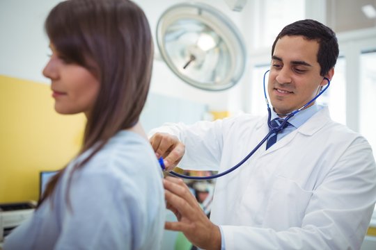Doctor examining a female patient