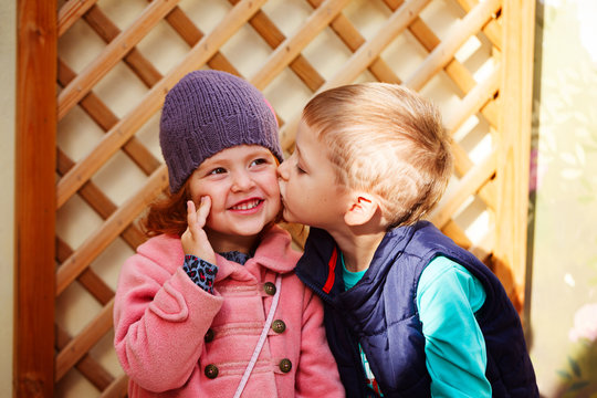Little boy kissed for the first time adorable little girl. Love and romantic concept