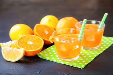 citrus juice and ingredients on a dark background, selective focus, copy space
