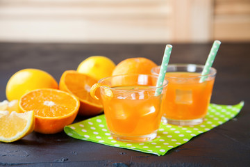 citrus juice and ingredients on a dark background, selective focus, copy space