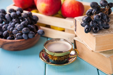 coffee in a cup, grapes and apples on a table, selective focus, copy space