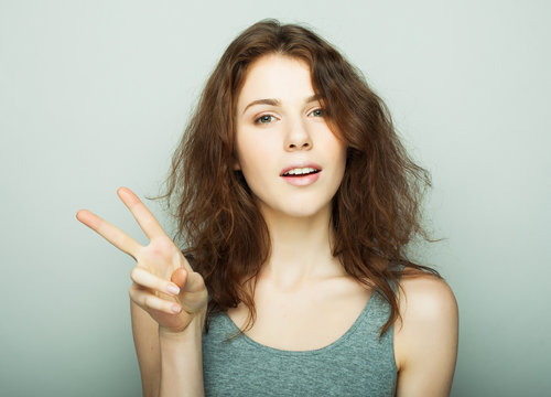 lovely woman showing victory or peace sign