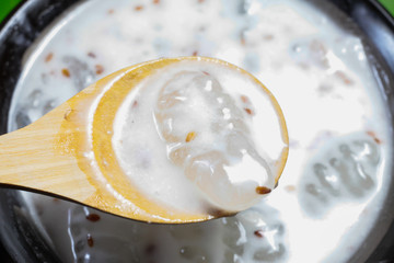 Caramelized crisps in coconut sauce. Thai dessert.