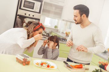 Happy family preparing food in kitchen