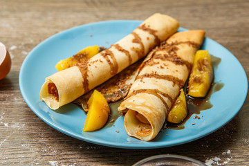 Pancakes with peaches and chocolate