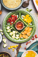 Healthy food with cut vegetables , pearl barley and feta cheese , top view