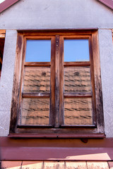 Historical House Roof and Attic Windows with reflection of red roof tiles.