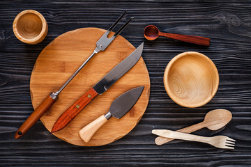 wooden kitchen utensils on dark background top view