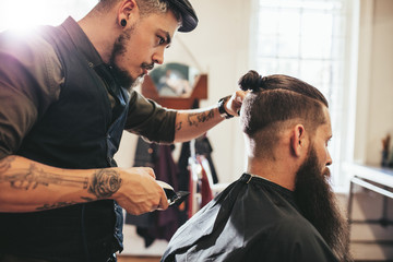 Beard man getting haircut at salon