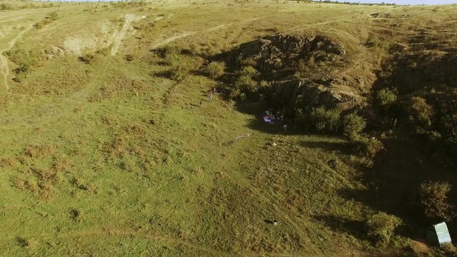 Tourists camping in picturesque landscape in wild nature. Panoramic shot from drone