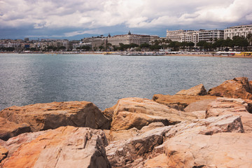 Fototapeta premium Buildings near seashore. Rocks, water and sky. Spend whole summer at resort.