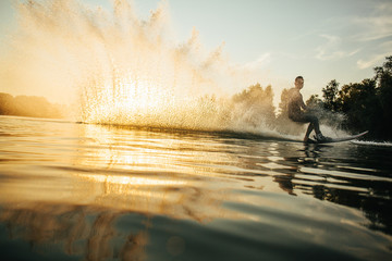Man wakeboarding on a lake - obrazy, fototapety, plakaty
