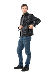 Casual man in jeans and leather jacket put mobile phone inside pocket. Full body length portrait isolated over white background.