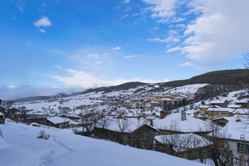 Fototapeta na wymiar Cloudy winter mountain village 