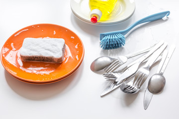 concept of washing dishes on white background top view