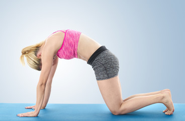 Fototapeta premium Woman making pilates mat exercises