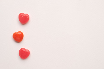 three Red Valentine's day heart shape candy line on white paper background. Love Concept. Minimalism style. Knolling top view.