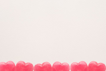 Pink Valentine's day heart shape lollipop candy on empty white paper background. Love Concept. Minimalism colorful hipster style.