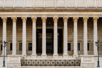 Neoclassical colonnade building front with corinthian style ornate columns. These architectural details are widely used for law courts, libraries, universities and other public buildings.