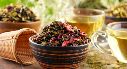 Fototapeta premium Composition with cup of tea and bowls of tea leaves