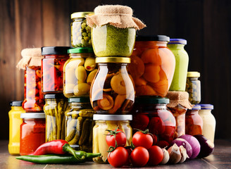 Jars with variety of pickled vegetables.