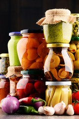 Jars with variety of pickled vegetables.