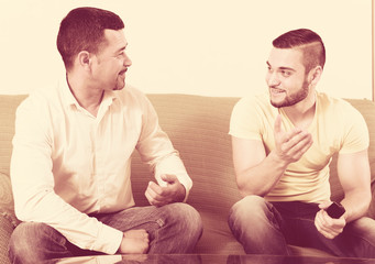 Two men talk