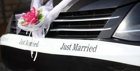 Wedding bouquet and sign on luxury car