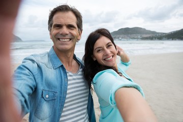 Obraz premium Portrait of couple enjoying on beach