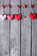 Valentine day background, handmade pillow hearts on wood, copy space