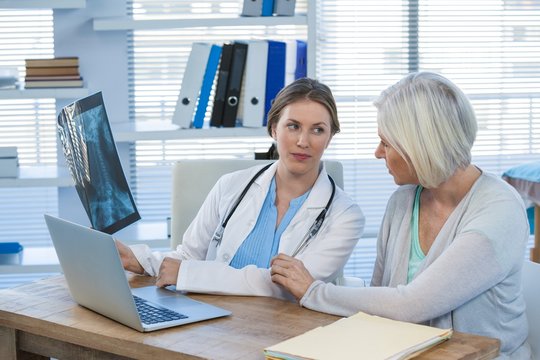 Female doctor explaining x-ray report to patient